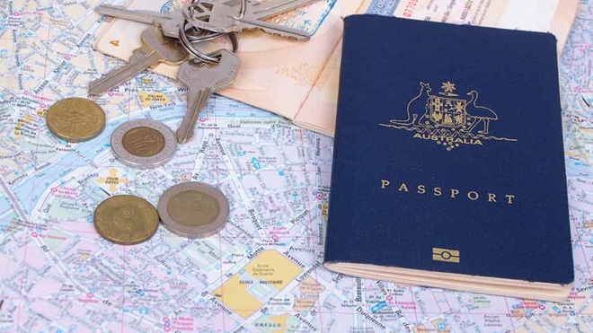 passport keys and coins on a map